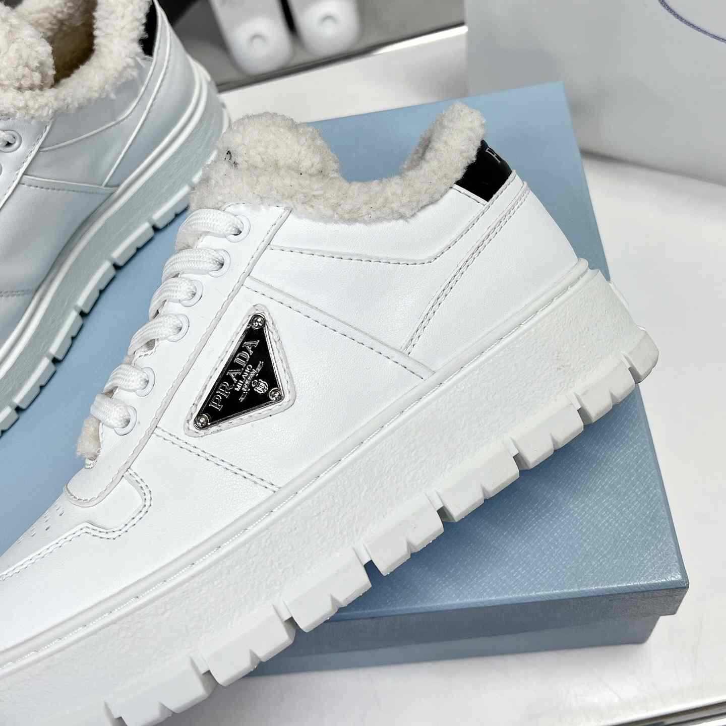 Prada Leather And Shearling Sneakers - everydesigner