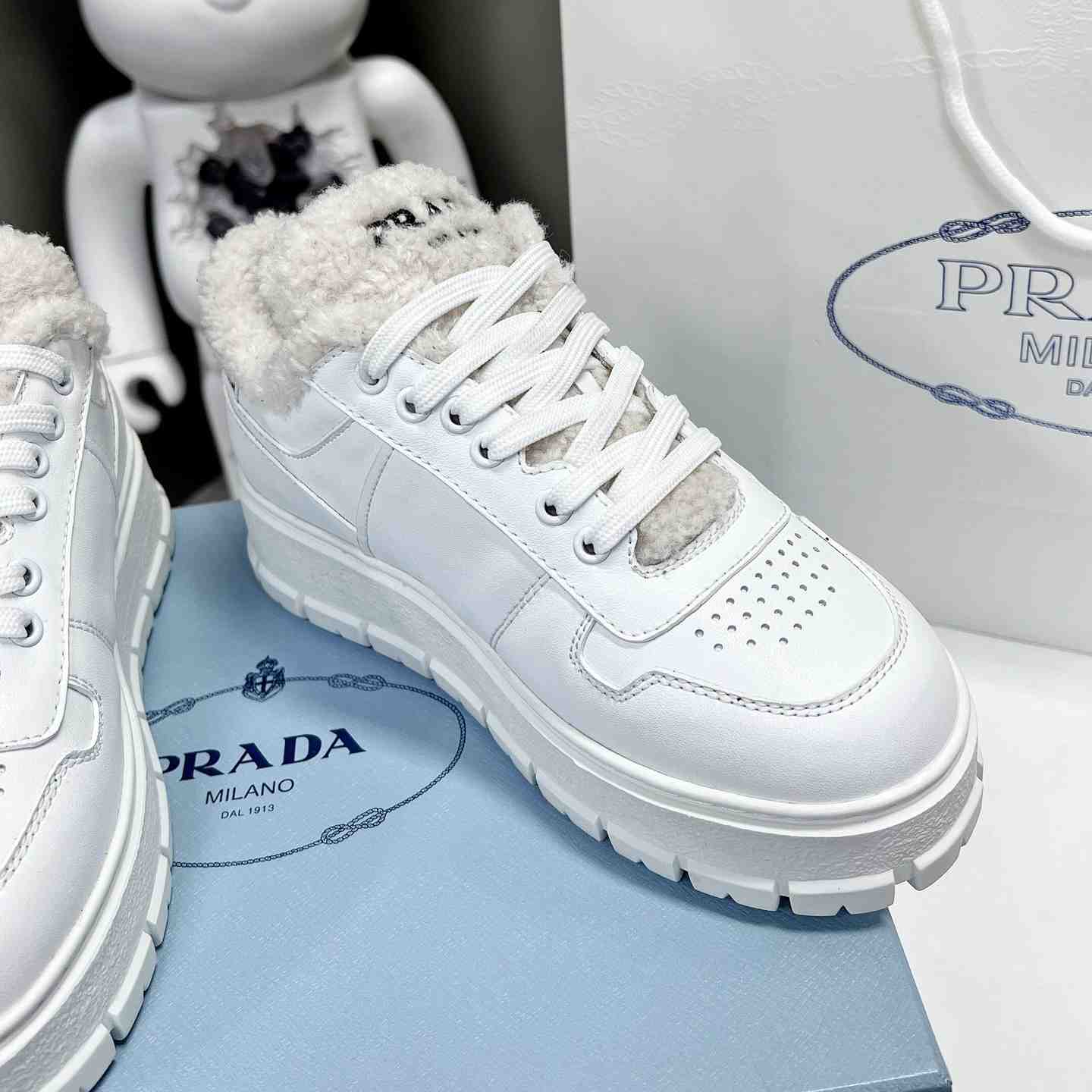 Prada Leather And Shearling Sneakers - everydesigner