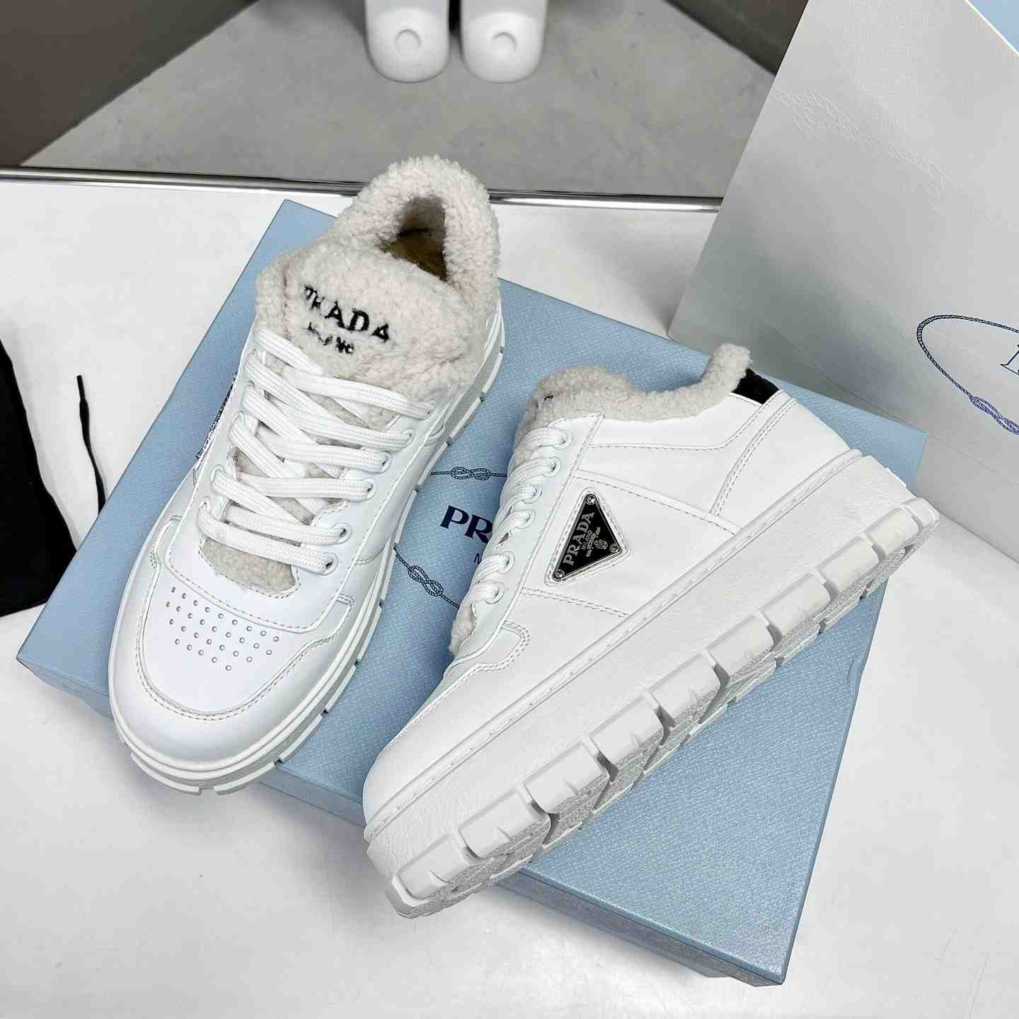 Prada Leather And Shearling Sneakers - everydesigner