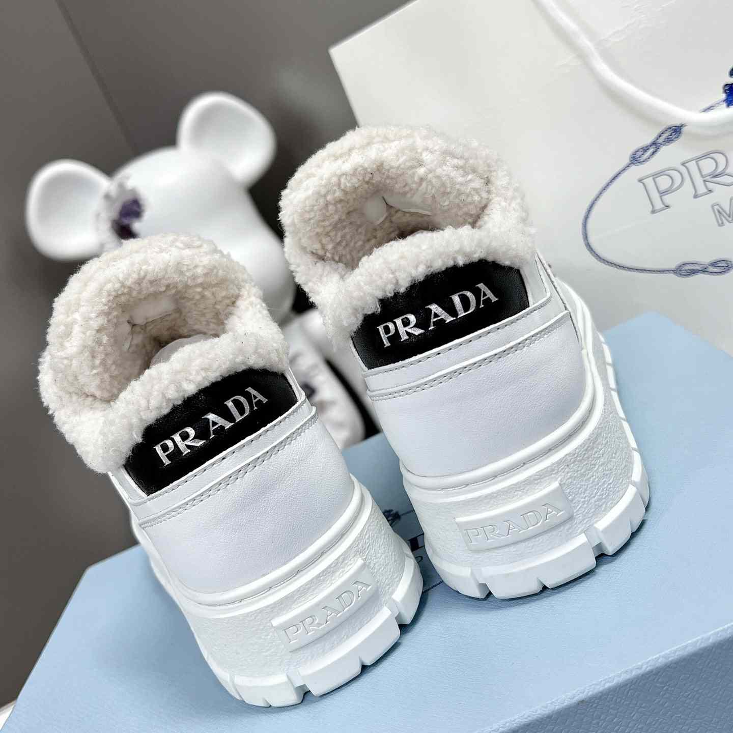 Prada Leather And Shearling Sneakers - everydesigner