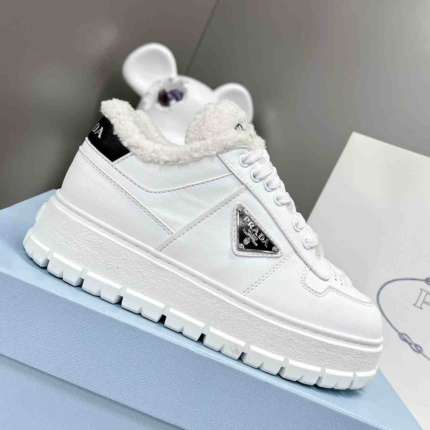 Prada Leather And Shearling Sneakers - everydesigner